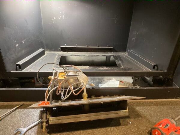 Fireplace Repair Coquitlam 2 Gas Fireplace Repair Coquitlam technician inspecting a gas fireplace