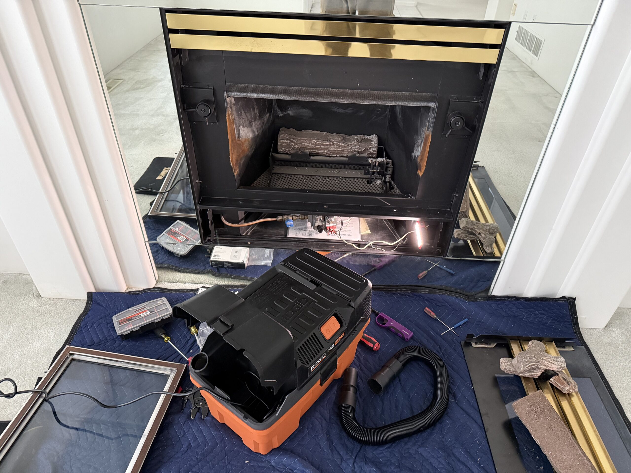 Technician repairing a gas fireplace in North Vancouver living room