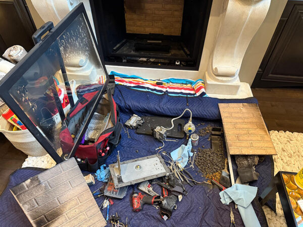 Fireplace Repair Port Coquitlam technician inspecting a gas fireplace