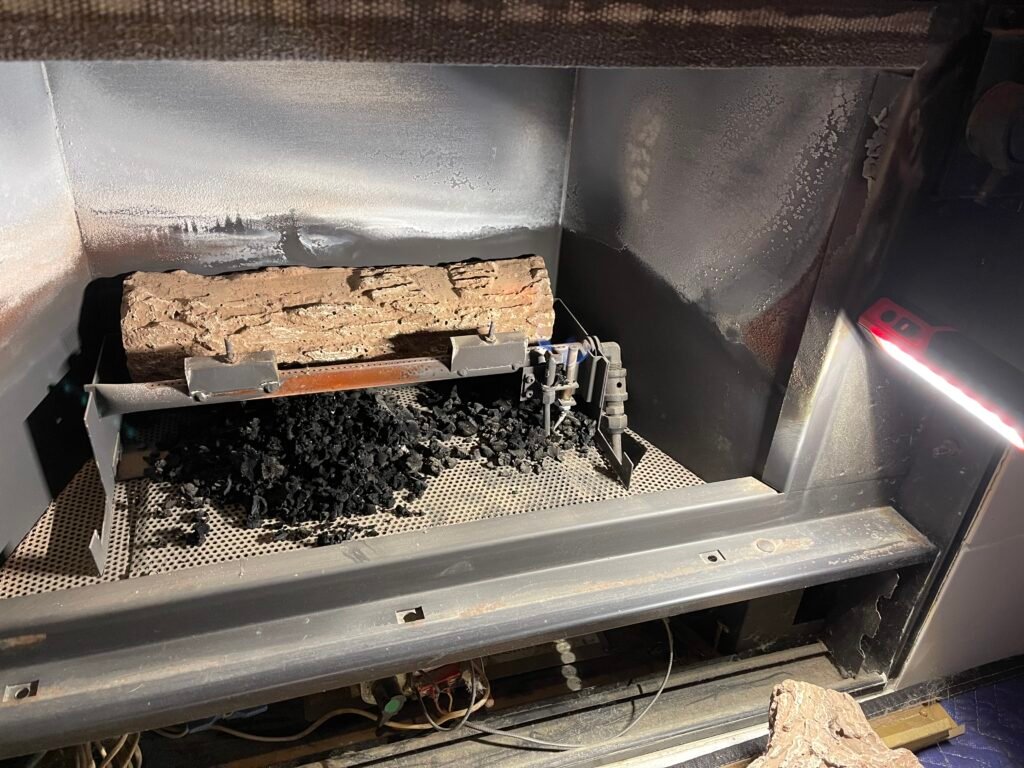 Black soot pattern on gas fireplace glass caused by incomplete combustion