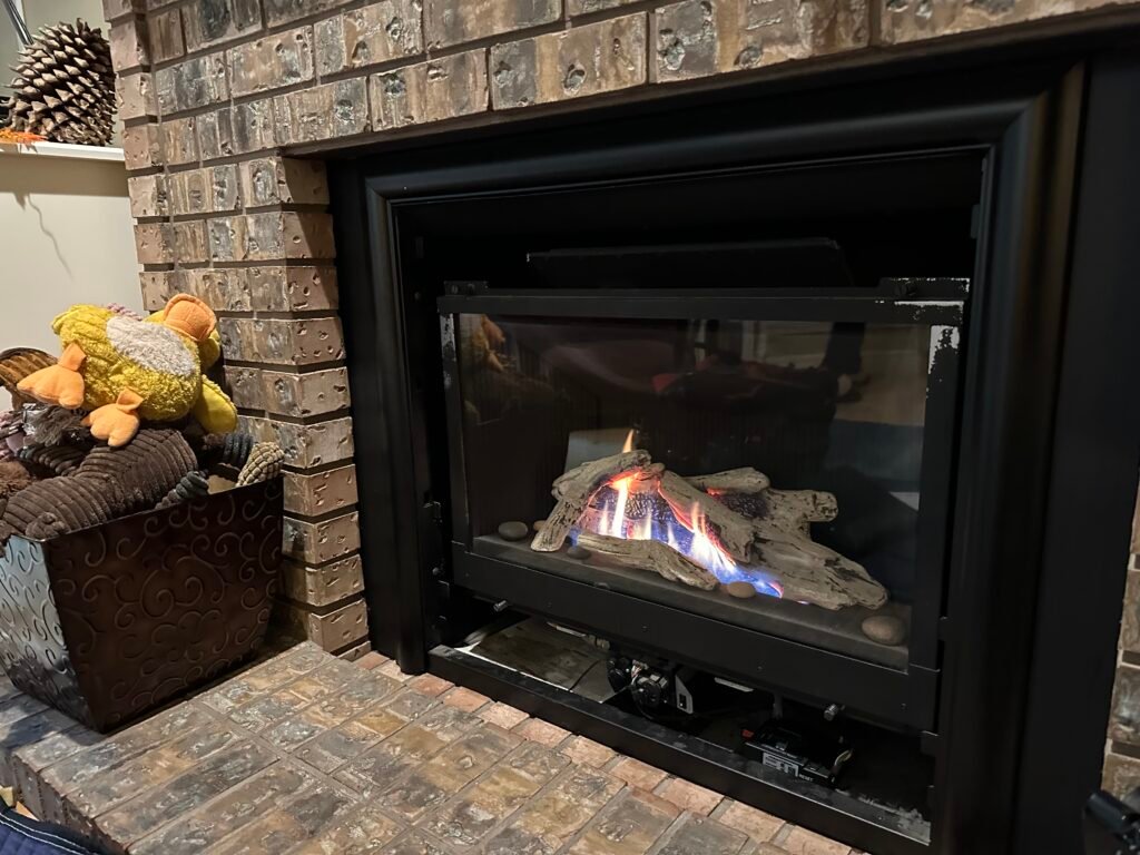 Licensed technician testing a gas fireplace heat