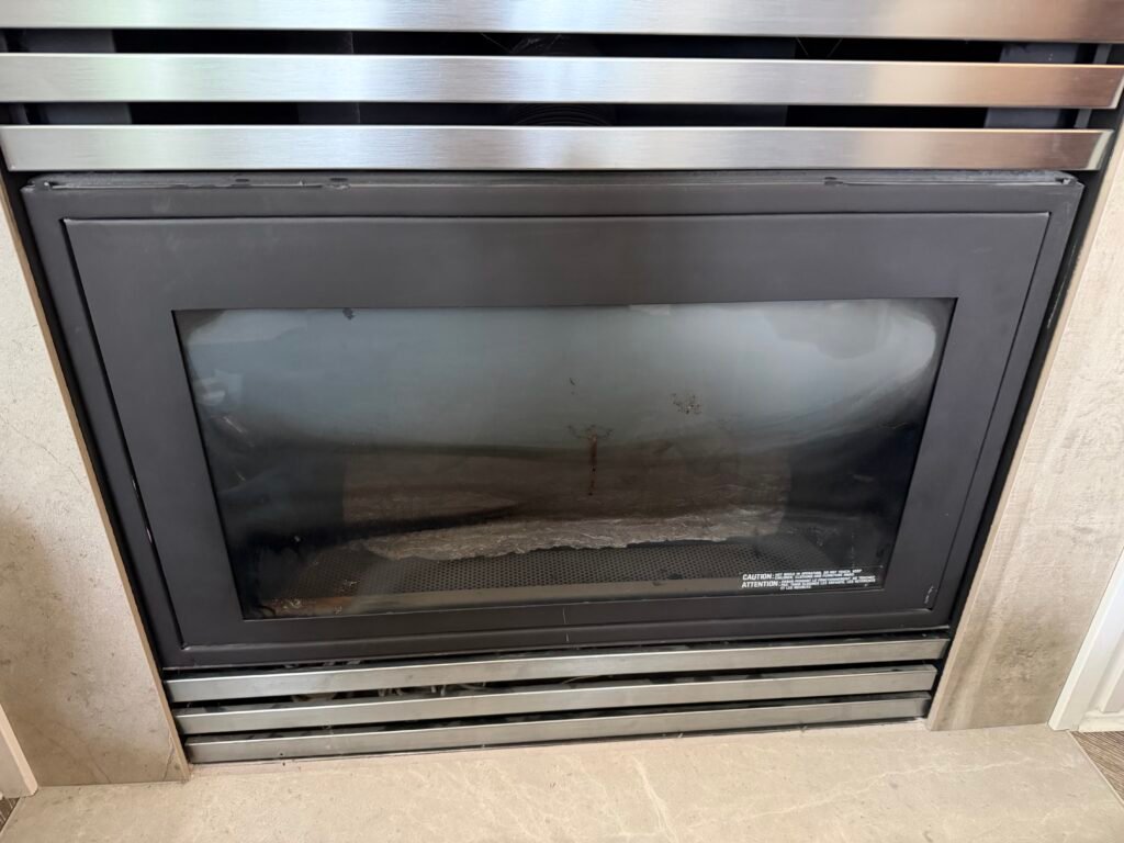 Black soot pattern on gas fireplace glass caused by incomplete combustion