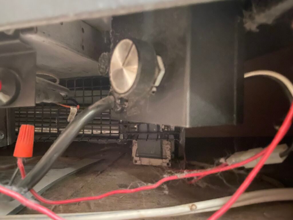 Gas fireplace blower motor and fan assembly inspected by a technician