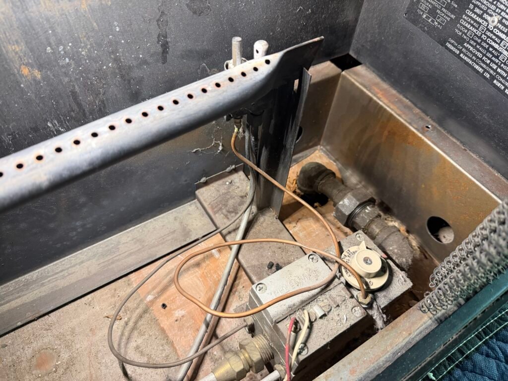 Gas fireplace burner ports and crossover ignition area