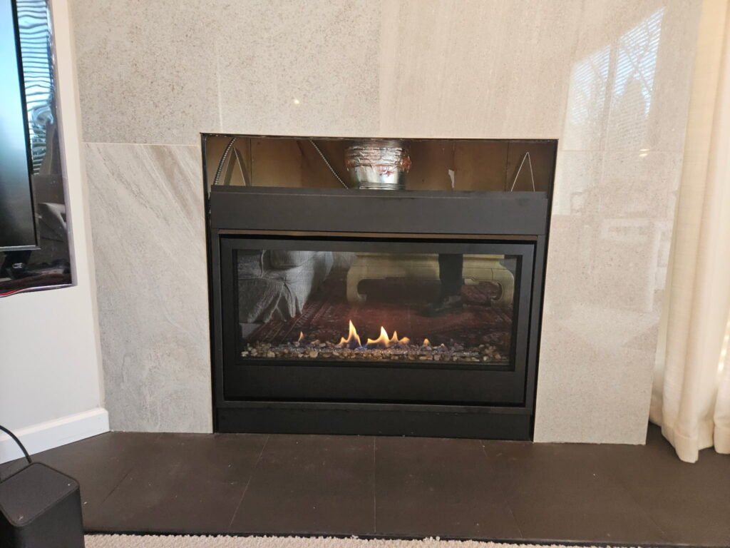 Gas fireplace installation in Vancouver with completed surround and venting